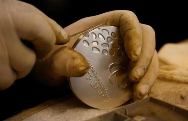 A worker from the Casa da Moeda do Brasil (Brazilian Mint) prepares a Rio 2016 Paralympic medal in Rio de Janeiro